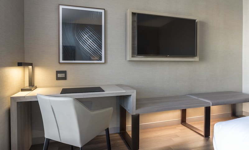 hotel room desk with bench seating