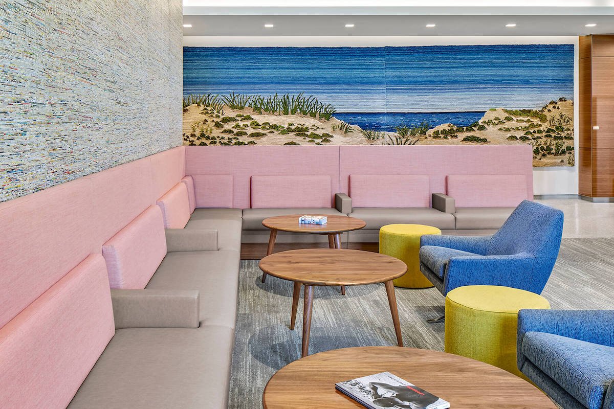 colorful lobby seating area with island beach wallpaper