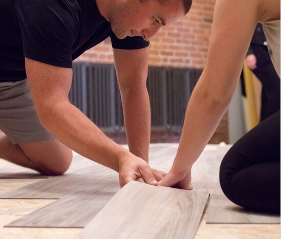 Commercial flooring team members looking a luxury vinyl tiles